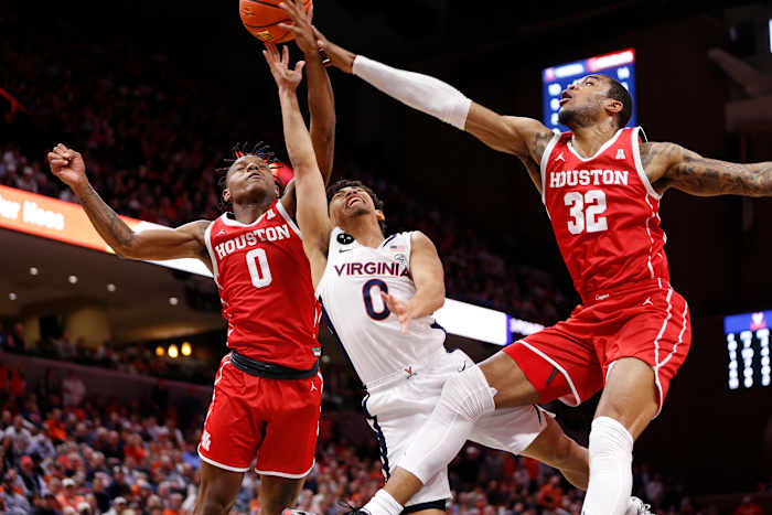 Dec 17, 2022; Charlottesville, Virginia, USA; Houston Cougars forward Reggie Chaney (32) and Cougars guard Marcus Sasser (0) block a shot by Virginia Cavaliers guard Kihei Clark (0) during the second half at John Paul Jones Arena. Mandatory Credit: Amber Searls-USA TODAY Sports